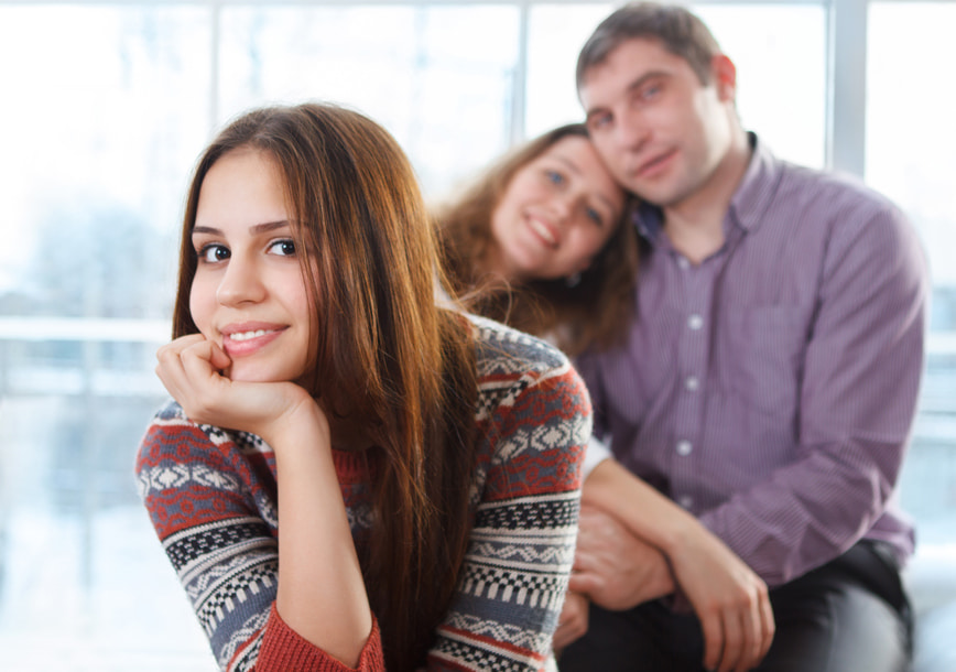 teenager and parents at the background