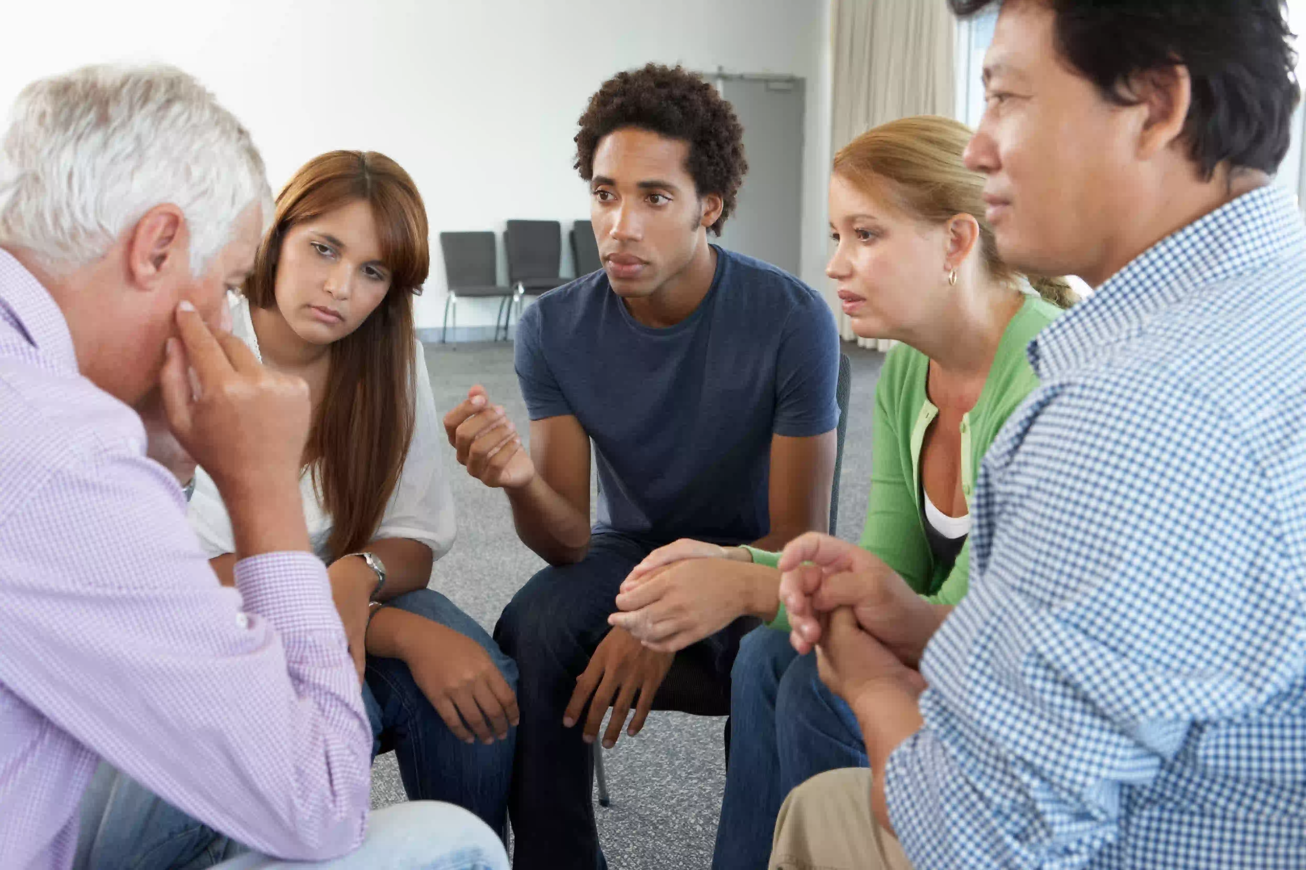 sad man in a circle of group session