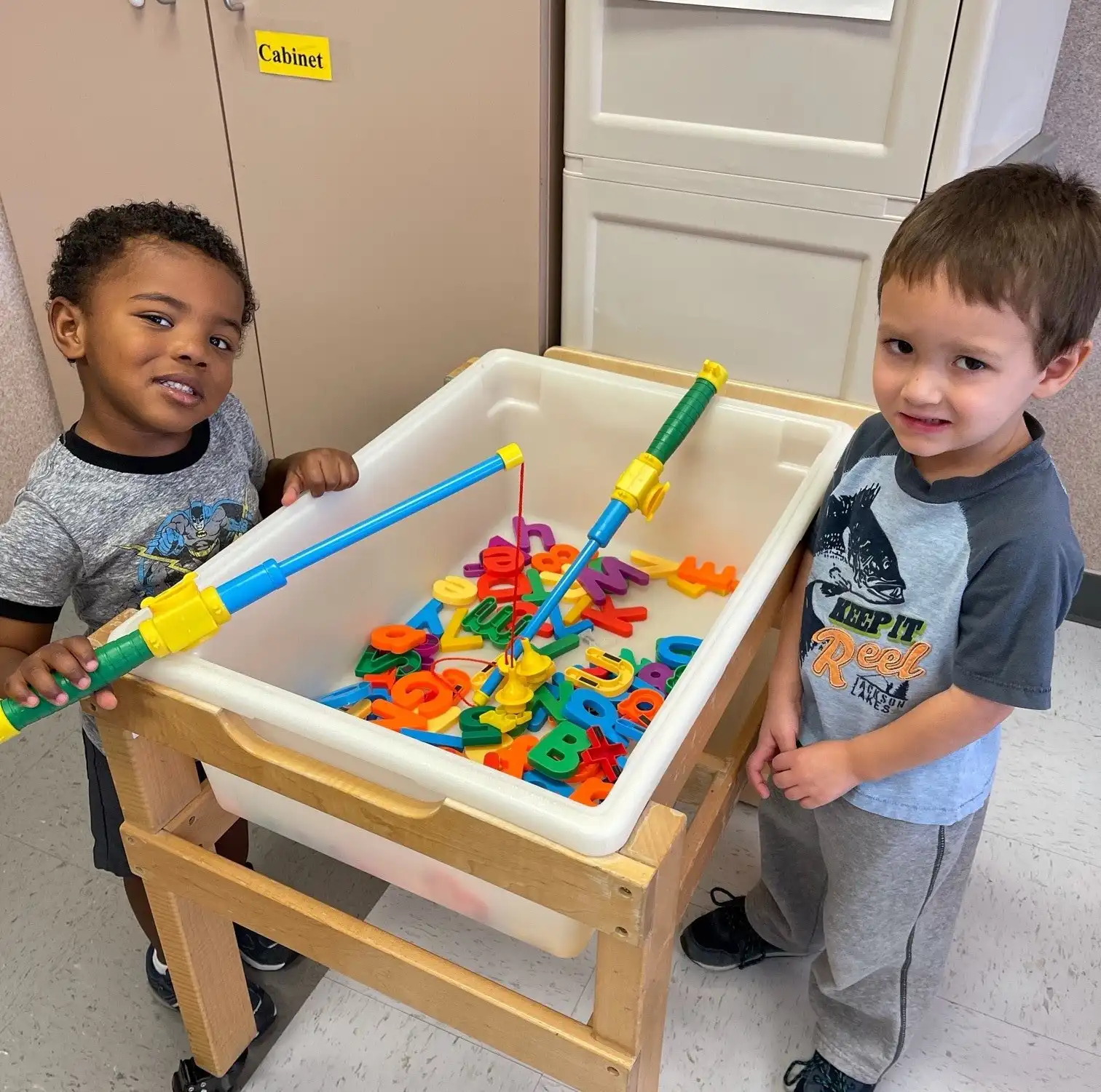 2 boys playing magnet letters