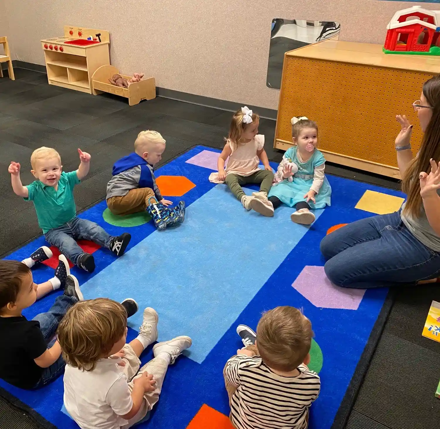 toddlers playing with an adult woman