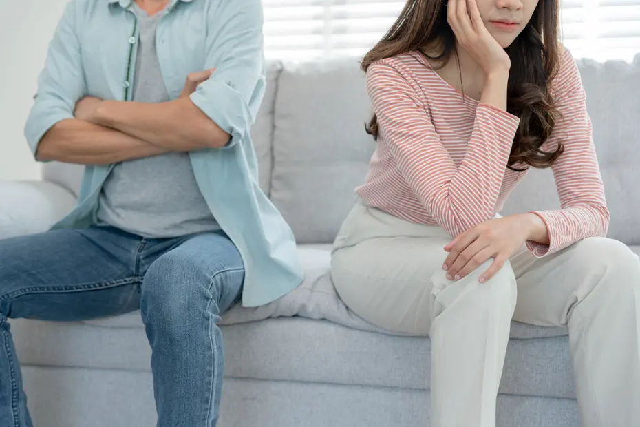 asian couple sitting opposite to each other