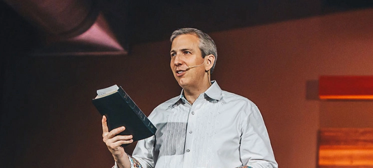 Pastor preaching holding a Bible